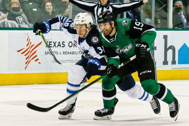 Texas Stars right wing Jeremy Gregoire (right) vs. the Manitoba Moose