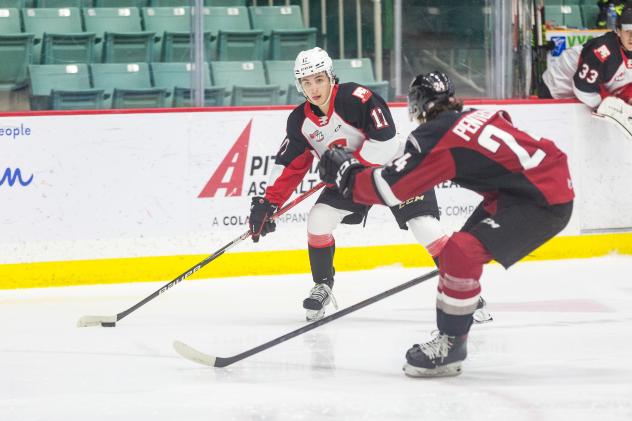 Prince George Cougars right wing Caden Brown looks to disburse the puck vs. the Vancouver Giants