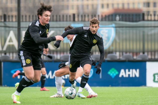 Wyatt Borso (left) and Russell Cicerone (center, on ball) of Pittsburgh Riverhounds SC vs. Villanova University