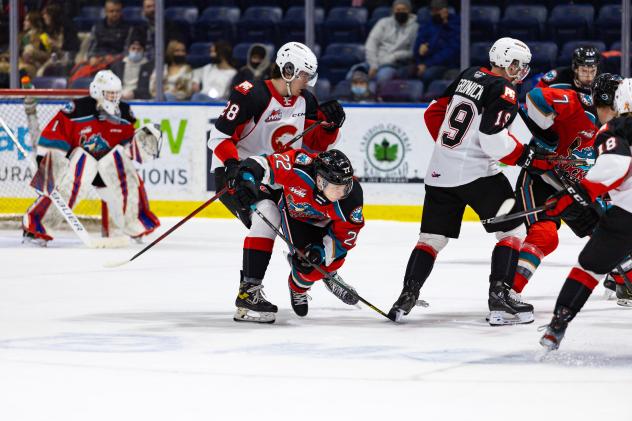 Kelowna Rockets left wing Gabriel Szturc (center) vs. the Prince George Cougars