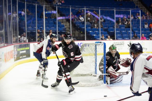 Rapid City Rush defenseman Kenton Helgeson (center) vs. the Tulsa Oilers