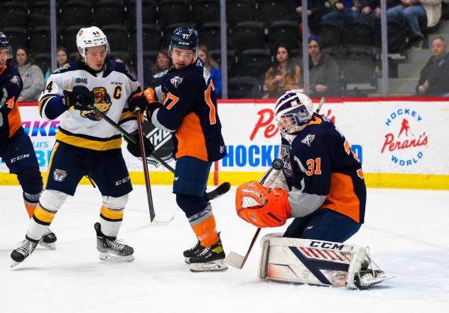 Erie Otters left wing Brendan Sellan (left) vs. the Flint Firebirds