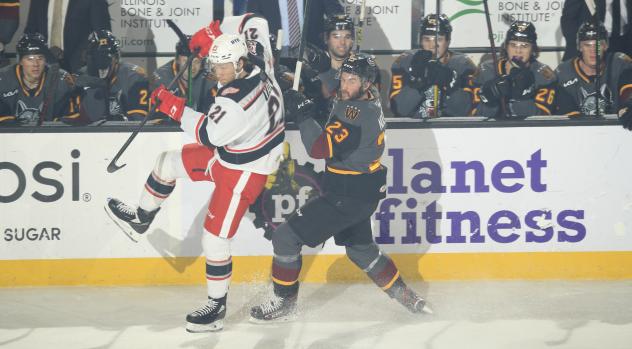 Grand Rapids Griffins left wing Dennis Yan (left) vs. the Chicago Wolves