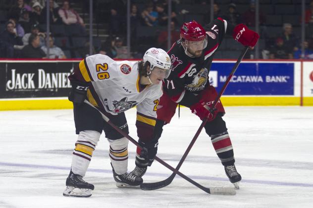 Grand Rapids Griffins right wing Jon Martin (right) faces off with the Chicago Wolves