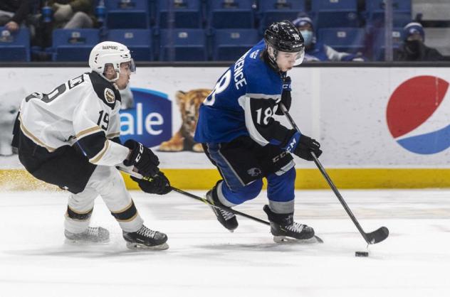 Saint John Sea Dogs centre Josh Lawrence (right) controls the puck vs. the Charlottetown Islanders