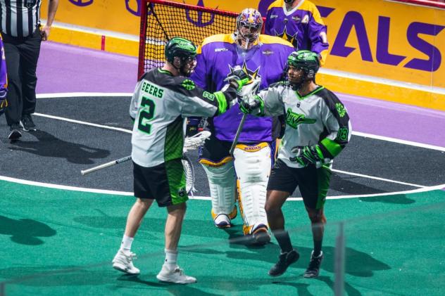 Saskatchewan Rush exchange congratulations after a goal against the San Diego Seals