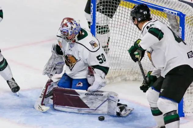 Utah Grizzlies goaltender Trent Miner stops a shot against the Tulsa Oilers