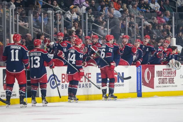 Allen Americans exchange high fives along the bench