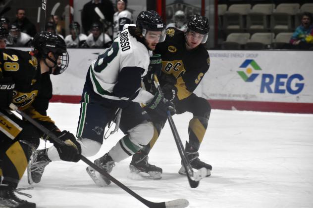 North Iowa Bulls forward Jake LaRusso battles Bismarck's Trevor Mitchell (right)