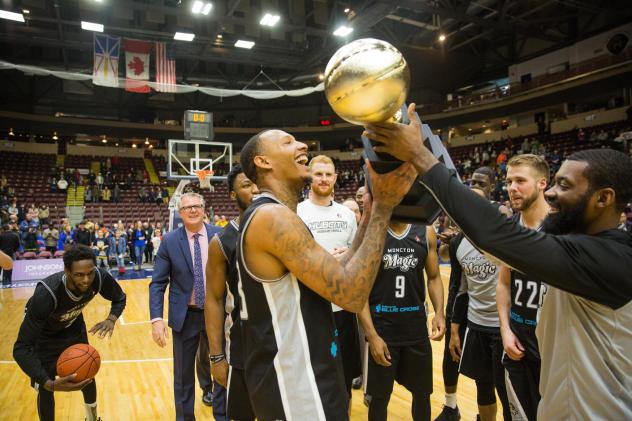 Billy White lifts the National Basketball League of Canada championship trophy with the Moncton Magic