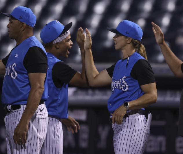 Tampa Tarpons manager Rachel Balkovec exchanges high fives with the team after a win