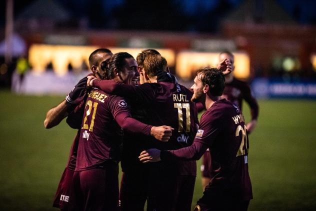 Detroit City FC huddles after a goal