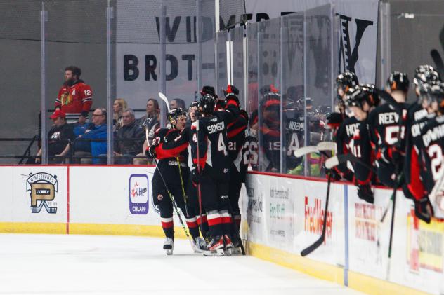 Prince George Cougars gather following a goal against the Portland Winterhawks