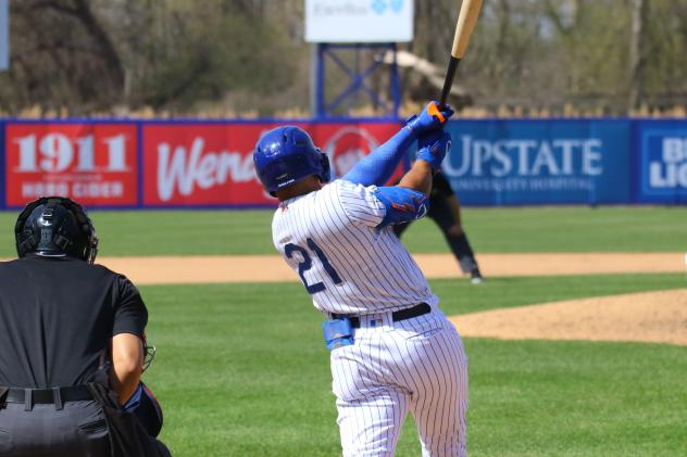 Nick Plummer of the Syracuse Mets swings and watches his go-ahead home run go over the right-field wall