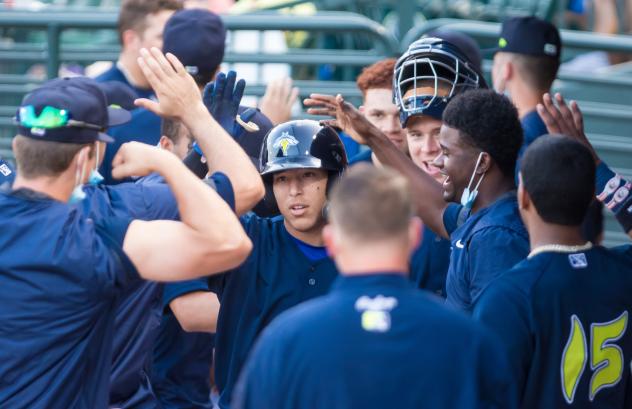 Columbia Fireflies congratulate Omar Hernandez on his game-winning hit