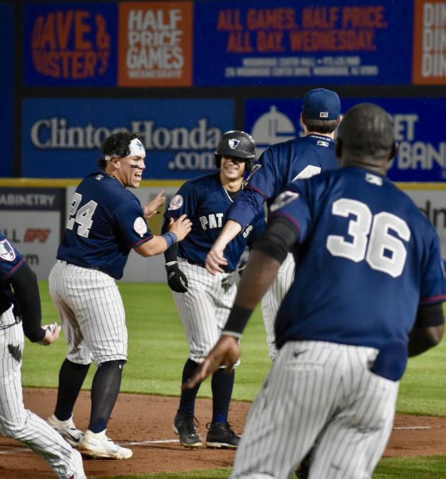 Somerset Patriots congratulate Mickey Gasper following his walk-off hit