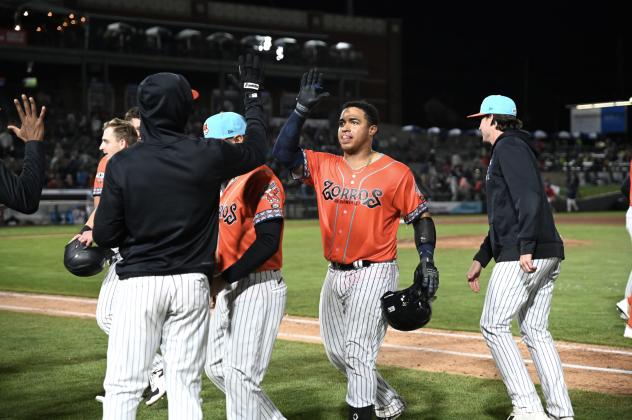 Saul Torres of the Somerset Patriots receives congratulations after he was hit by a pitch