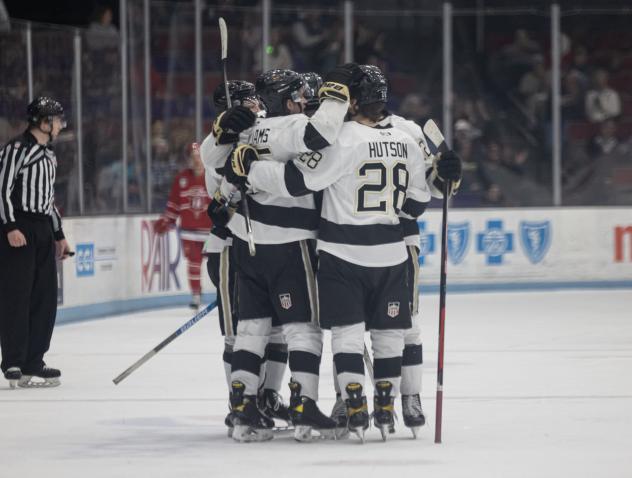 Quinn Hutson and the Muskegon Lumberjacks huddle after a goal