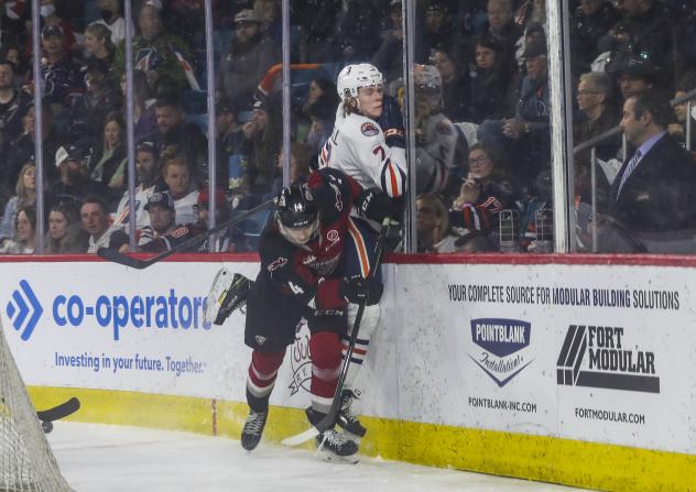 Ethan Semeniuk of the Vancouver Giants takes out Kaden Hammell of the Kamloops Blazers on the forecheck
