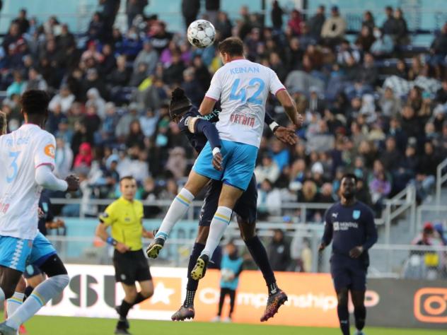 Las Vegas Lights FC defender Dekel Keinan goes high for a ball against Monterey Bay FC