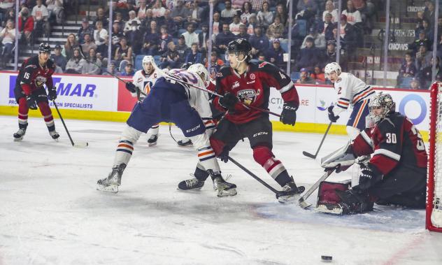 Vancouver Giants defenceman Cadieux (center) vs. the Kamloops Blazers