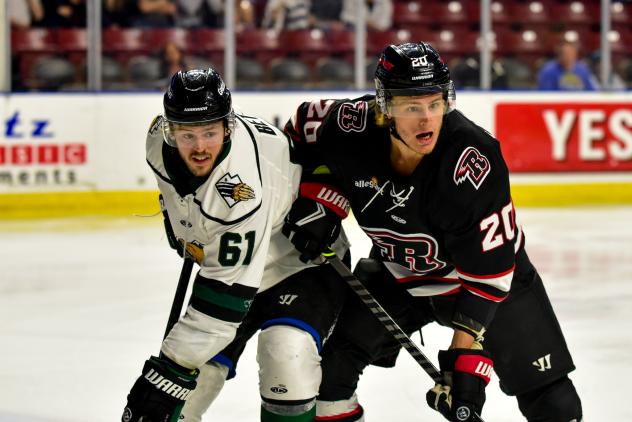 Rapid City Rush defenseman Tyson Helgesen (right) vs. the Utah Grizzlies