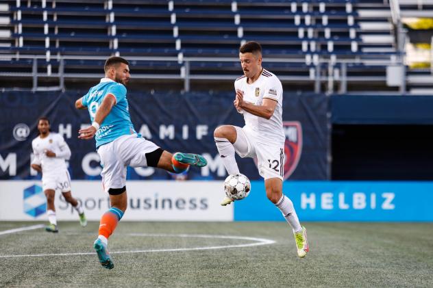 Detroit City FC midfielder Michael Bryant (right) vs. The Miami FC