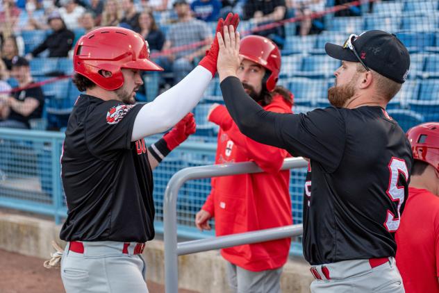 Ottawa Titans exchange a high five after scoring against the Windy City ThunderBolts