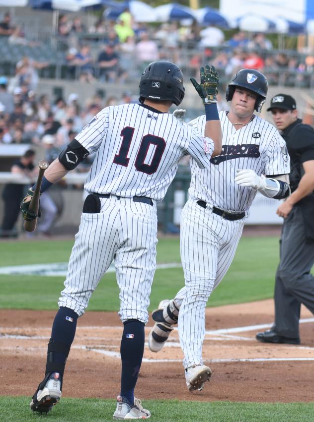 Josh Breaux of the Somerset Patriots gets a high five after his home run