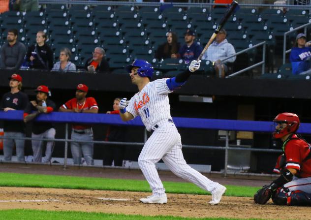 Nick Dini of the Syracuse Mets watches his home run fly out of the stadium