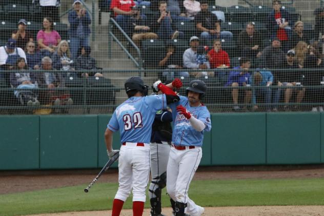 The Tri-City Dust Devils, playing as the Columbia River Rooster Tails, celebrate after a homer