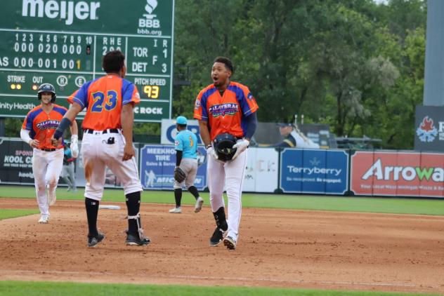 Infielder Jose King and the West Michigan Whitecaps celebrate a walk-off win