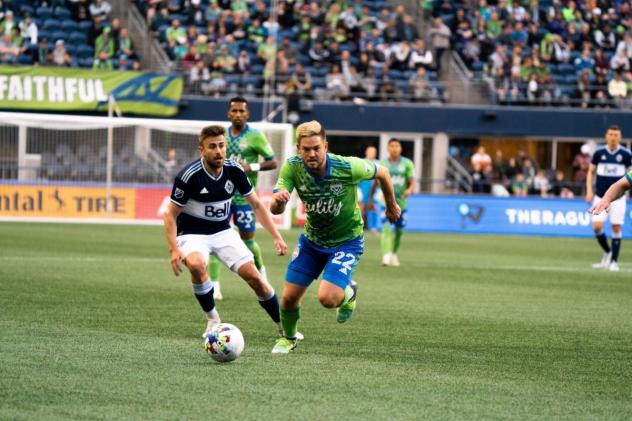 Seattle Sounders FC midfielder Kelyn Rowe races for the ball