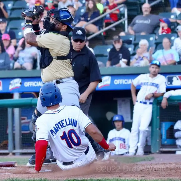 New York Boulders' Gian Martellini slides safely into home plate