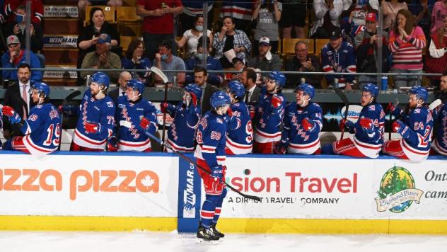 Kitchener Rangers offer congratulations along the bench to Mitchell Martin