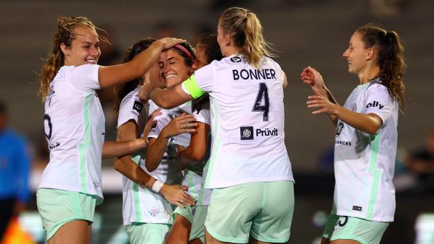 Racing Louisville FC midfielder Savannah DeMelo is congratulated by teammates