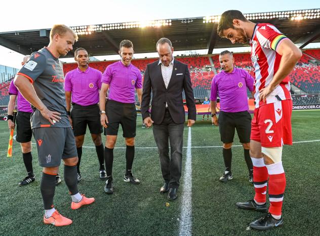 CPL Commissioner Mark Noonan conducts the coin toss as Atlético Ottawa takes on Forge FC