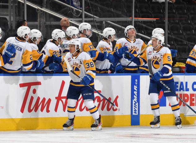 Saskatoon Blades' Aidan De La Gorgendiere  and Trevor Wong congratulate team