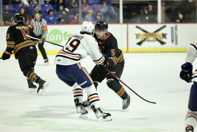 Vancouver Giants' Carson Haynes battles Kamloops Blazers' Caedan Bankier
