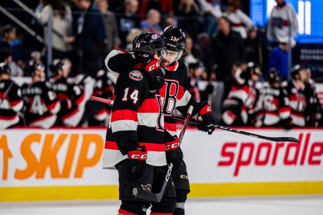 Belleville Senators forward Rourke Chartier receives a congratulatory hug against the Laval Rocket