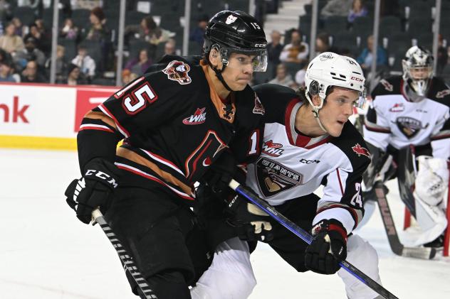 Vancouver Giants centre Jaden Lipinski (right) vs. the Calgary Hitmen