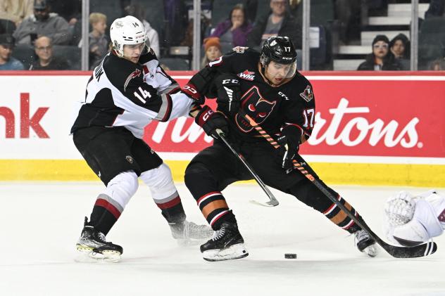 Vancouver Giants centre Ethan Semeniuk (left) vs. the Calgary Hitmen