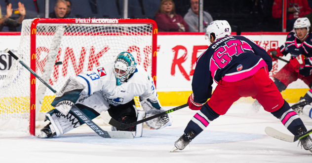 Wichita Thunder goaltender Strauss Mann fends off a shot by the Allen Americans
