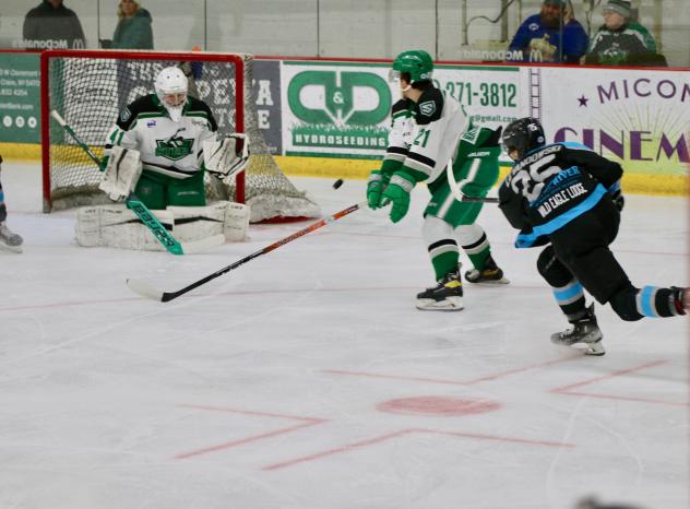 Luke Levandowski of the Wisconsin Windigo (right) fires a shot against the Chippewa Steel
