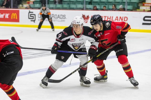 Vancouver Giants' Julian Cull and Prince George Cougars' Noah Boyko in action