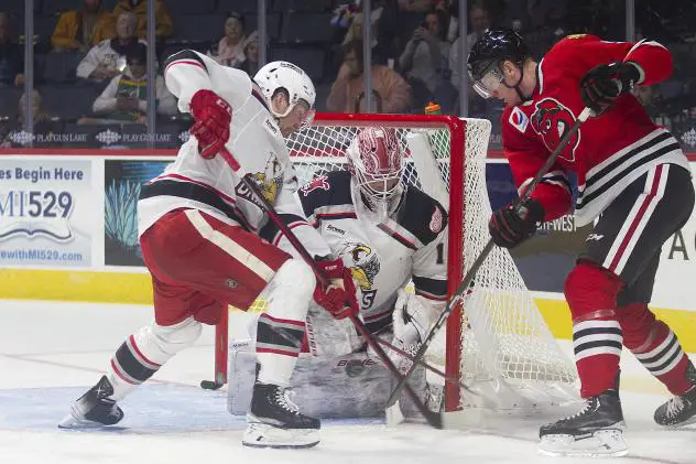 Grand Rapids Griffins goaltender Victor Brattstrom tries to keep the Rockford IceHogs from scoring