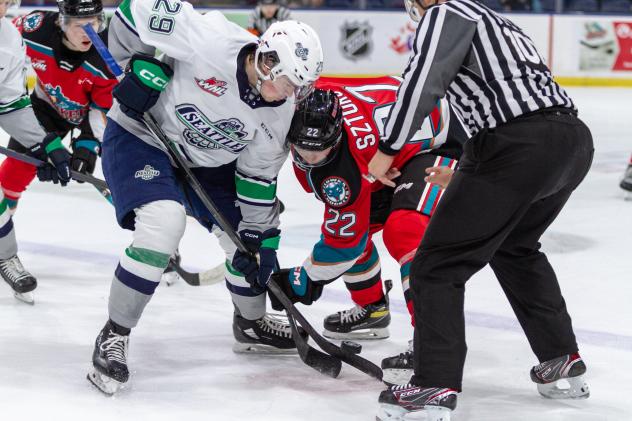 Kelowna Rockets forward Gabriel Szturc (right) faces off with the Seattle Thunderbirds