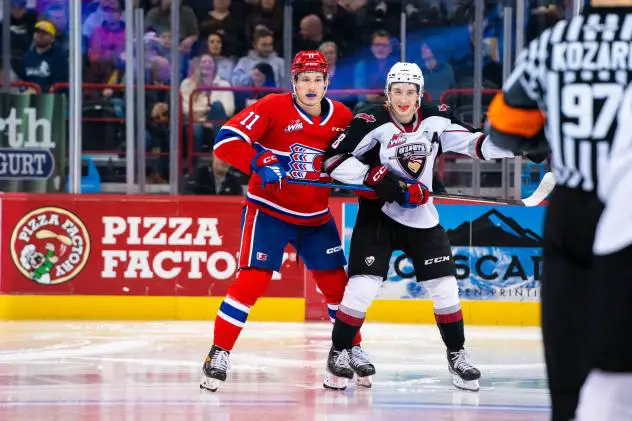 Spokane Chiefs' Ty Cheveldayoff and Vancouver Giants' Ty Thorpe on the ice