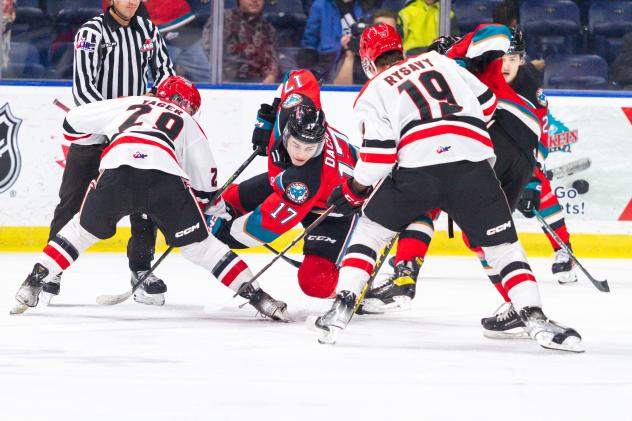 Kelowna Rockets' Colton Dach battles Brayden Yager and Martin Rysavy of the Moose Jaw Warriors