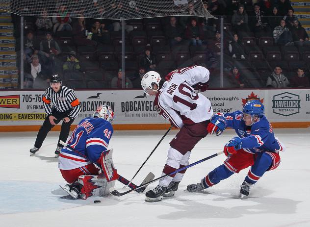 Peterborough Petes' J.R. Avon battles Marcus Vandenberg and Hunter Brzustewicz of the Kitchener Rangers